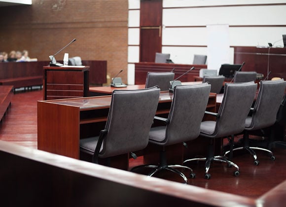 Chairs in a row, in a courtroom.